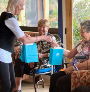 handing out gift bags for new members